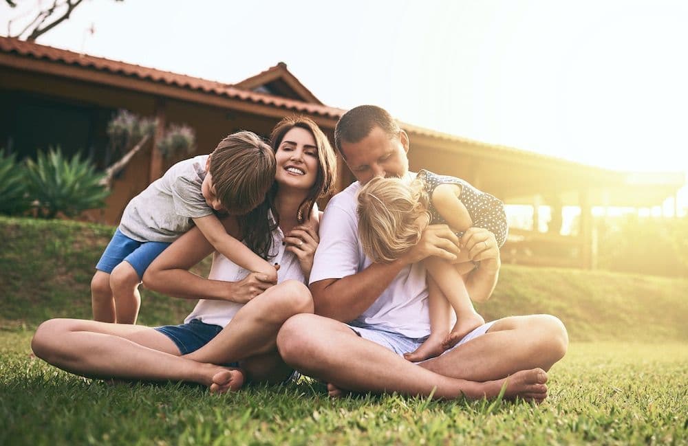 family on grass in yard